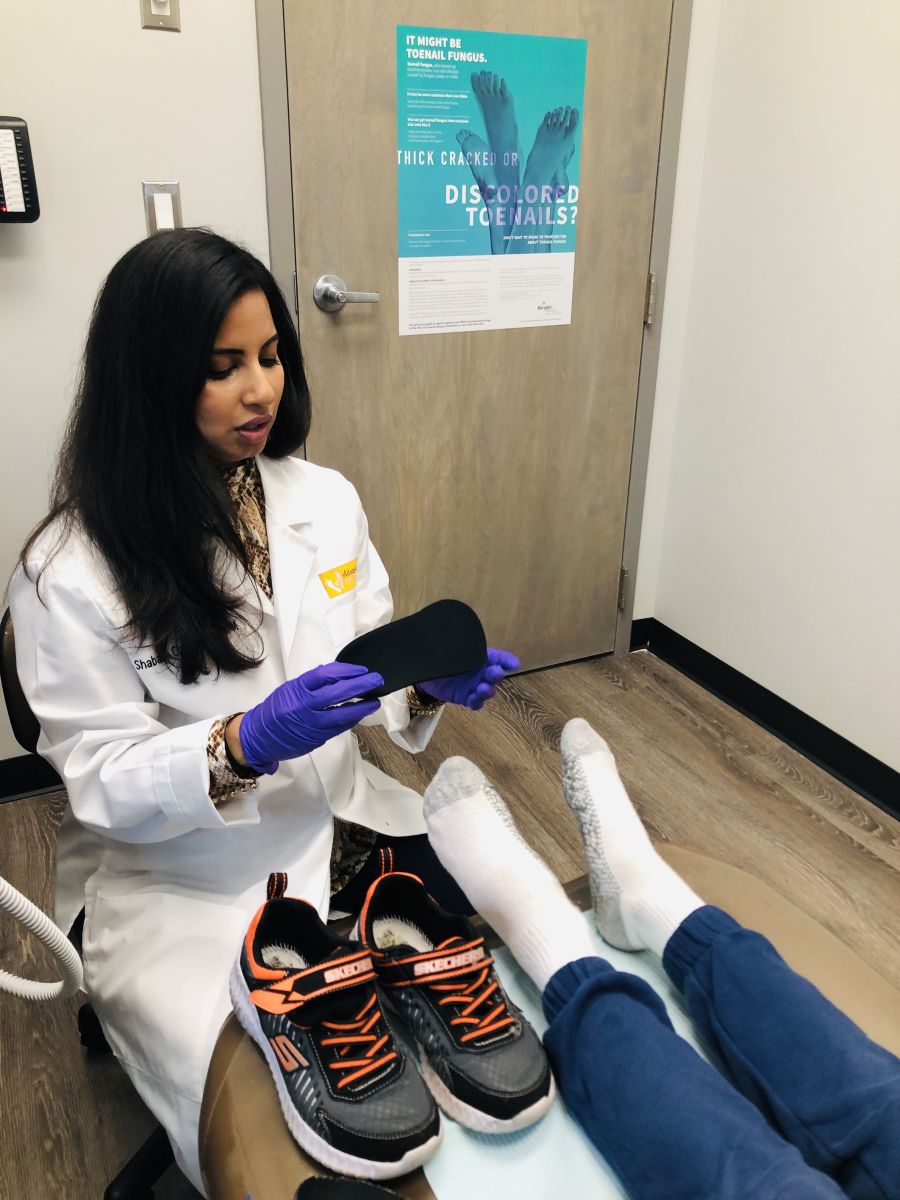 Dr. Chowdhury, a podiatrist on Long Island, seeing a patient.