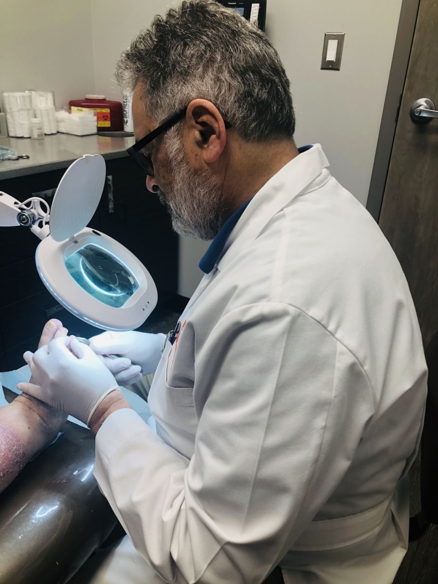 Podiatrist examining a foot.